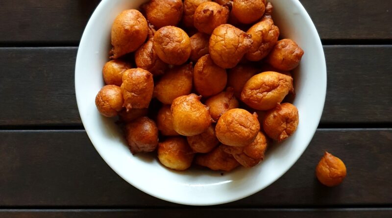 overhead view of fritule,sweet food in bowl on table