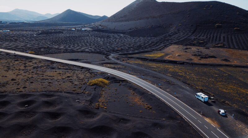 Volcanic landscape viewed from drone with holes to produce wine in agriculture business